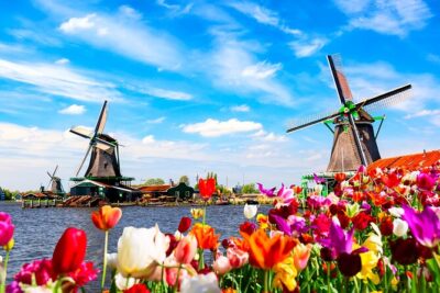 Amsterdam: Windmills, Cheese and Volendam Tour with Video Guide - Enter Zaanse Schans: windmills, canals, and clog craft