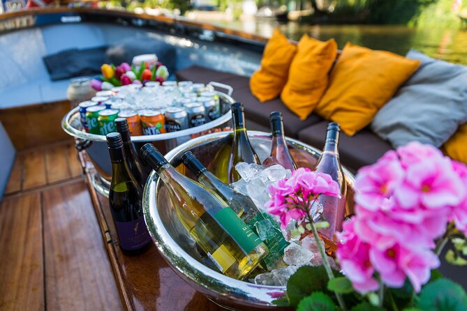 Classic Salonboat Tour in Amsterdam Including Cheese and Wine - Jordaan and the in-between streets: gardens, boutiques, and canal life
