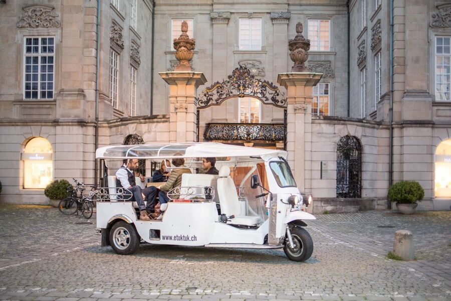 Zurich: Swiss Cheese Fondue and Wine e-Tuk-Tuk Tour - The Ride Begins: Local Stories While You Roll Through Zurich